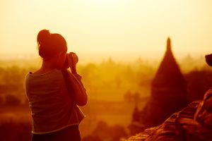 Woman photographing temple