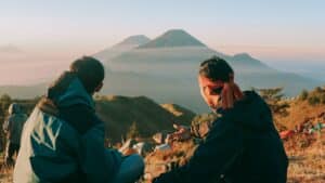 Two guys admiring a mountain at sunrise 