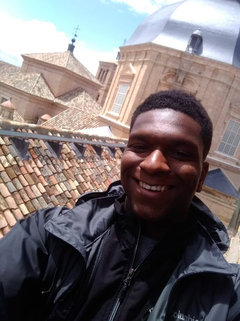 The author poses on a rooftop in Spain.