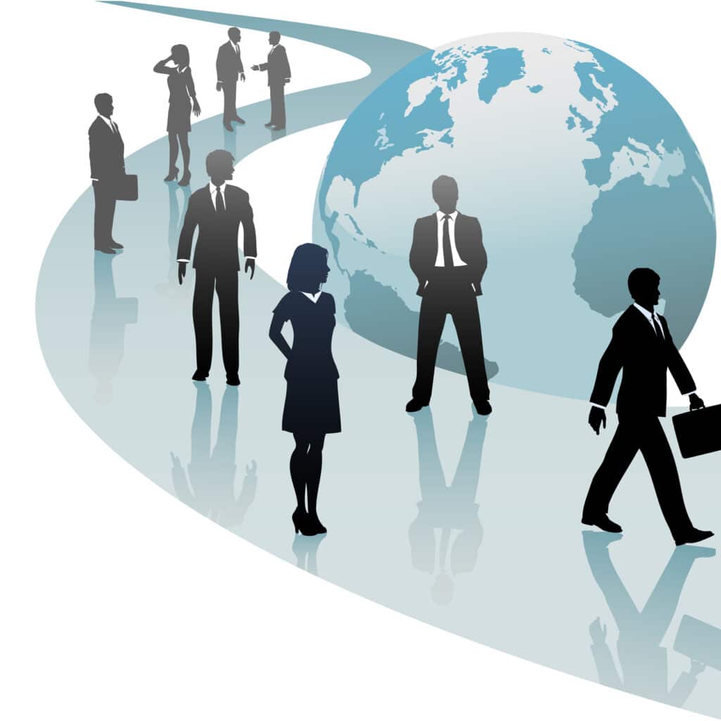 Silhouetted business people stand and walk along a path next to a globe of the planet