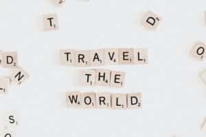 Image of scrabble pieces spelling "Travel the World."